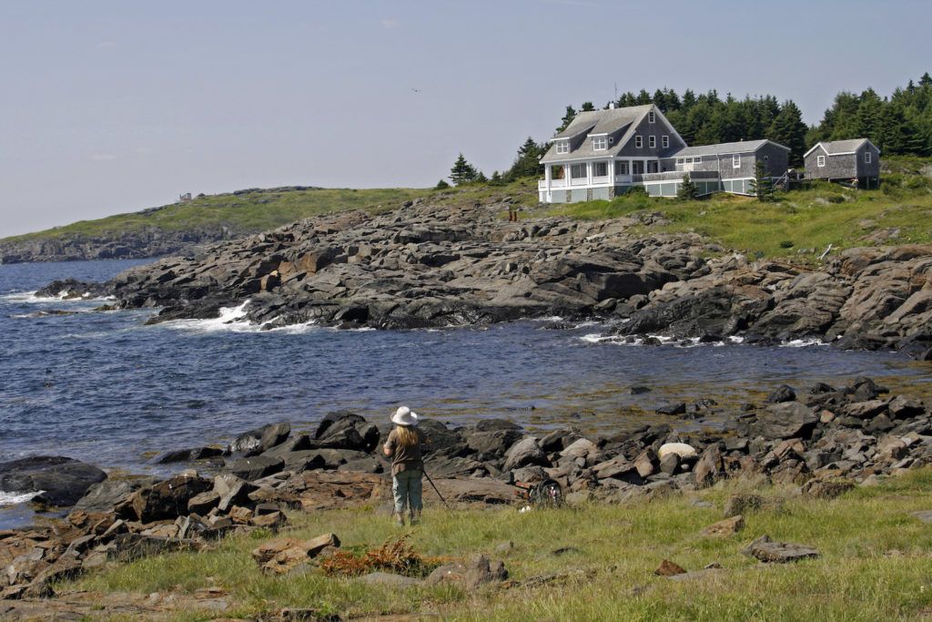 Artist painting on Monhegan Island, Maine, photo by Getty Images | 10 Places to Paint en Plein Air | Artists Network